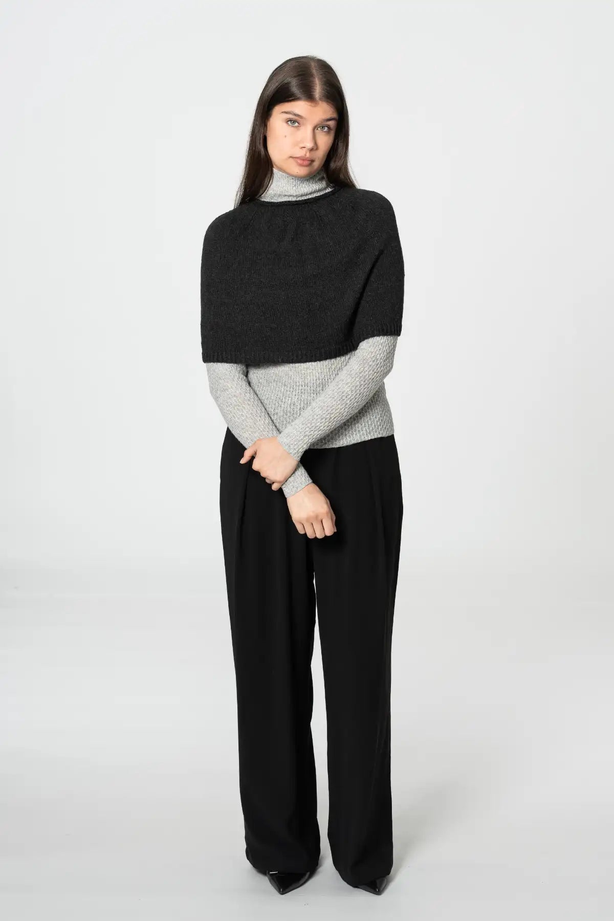 Dinadi black poncho cardigan layered over a gray turtleneck with stylish wide-leg pants in Kelowna and Canada