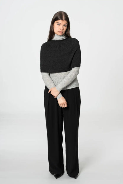 Dinadi black poncho cardigan layered over a gray turtleneck with stylish wide-leg pants in Kelowna and Canada