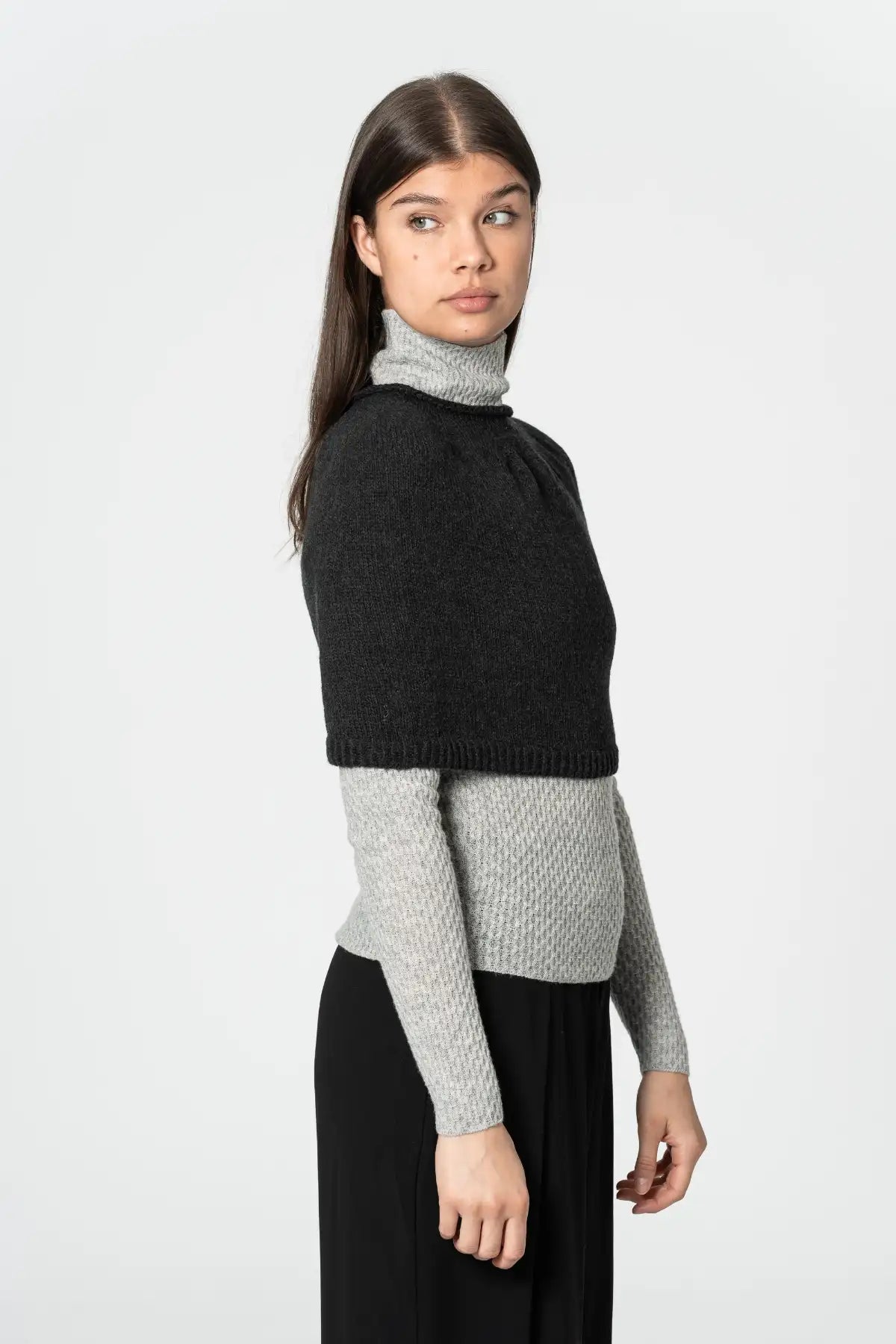 Dinadi black poncho with cropped design, perfect for layering over sweaters and tops in Kelowna and Canada