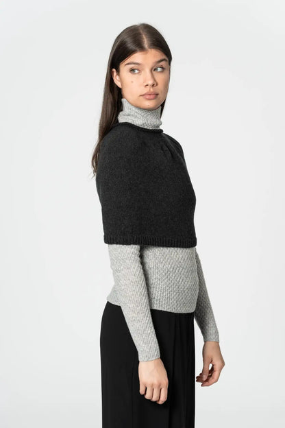 Dinadi black poncho with cropped design, perfect for layering over sweaters and tops in Kelowna and Canada