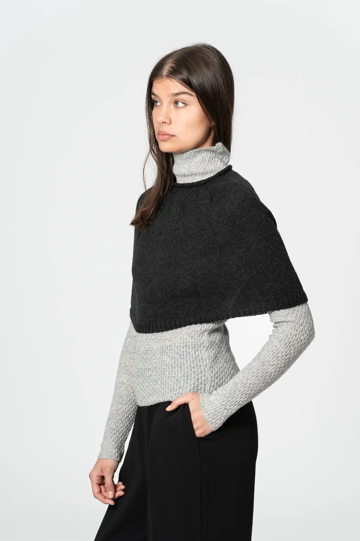 Dinadi two-tone poncho with a turtleneck design worn over a long-sleeve grey sweater in Kelowna and Canada