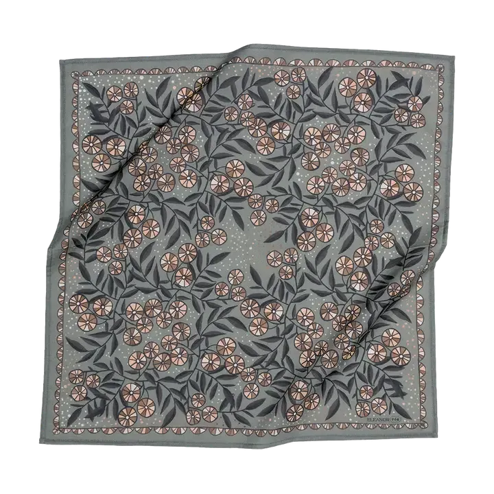 A square bandana with a gray-green background, featuring an all-over floral pattern in dusty pink, beige, and dark gray-green, finished with a decorative border.