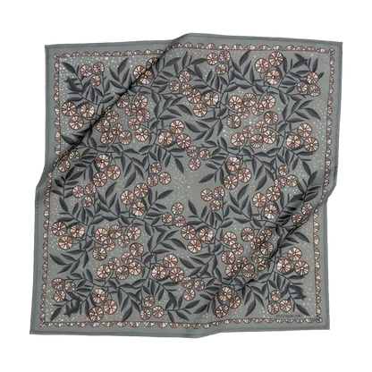 A square bandana with a gray-green background, featuring an all-over floral pattern in dusty pink, beige, and dark gray-green, finished with a decorative border.