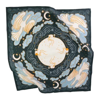 A square silk scarf featuring a celestial design with a central sun, surrounding birds, crescent moons, stars, and zodiac symbols in light blue, cream, and gold on a dark navy background.