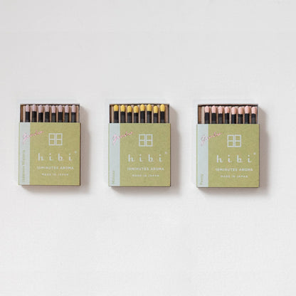 Three boxes of hibi matches on a white background