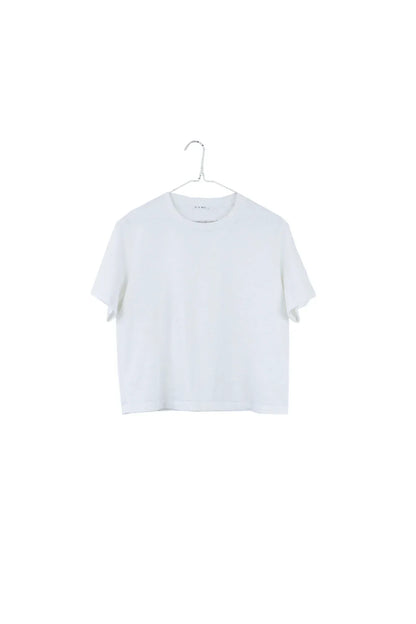 A white short-sleeve cropped T-shirt hanging on a metal hanger against a plain white background.