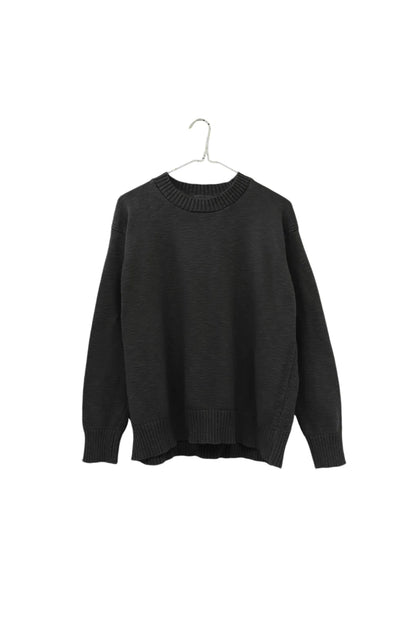 A dark charcoal gray knit sweater hanging on a hanger against a plain white background.