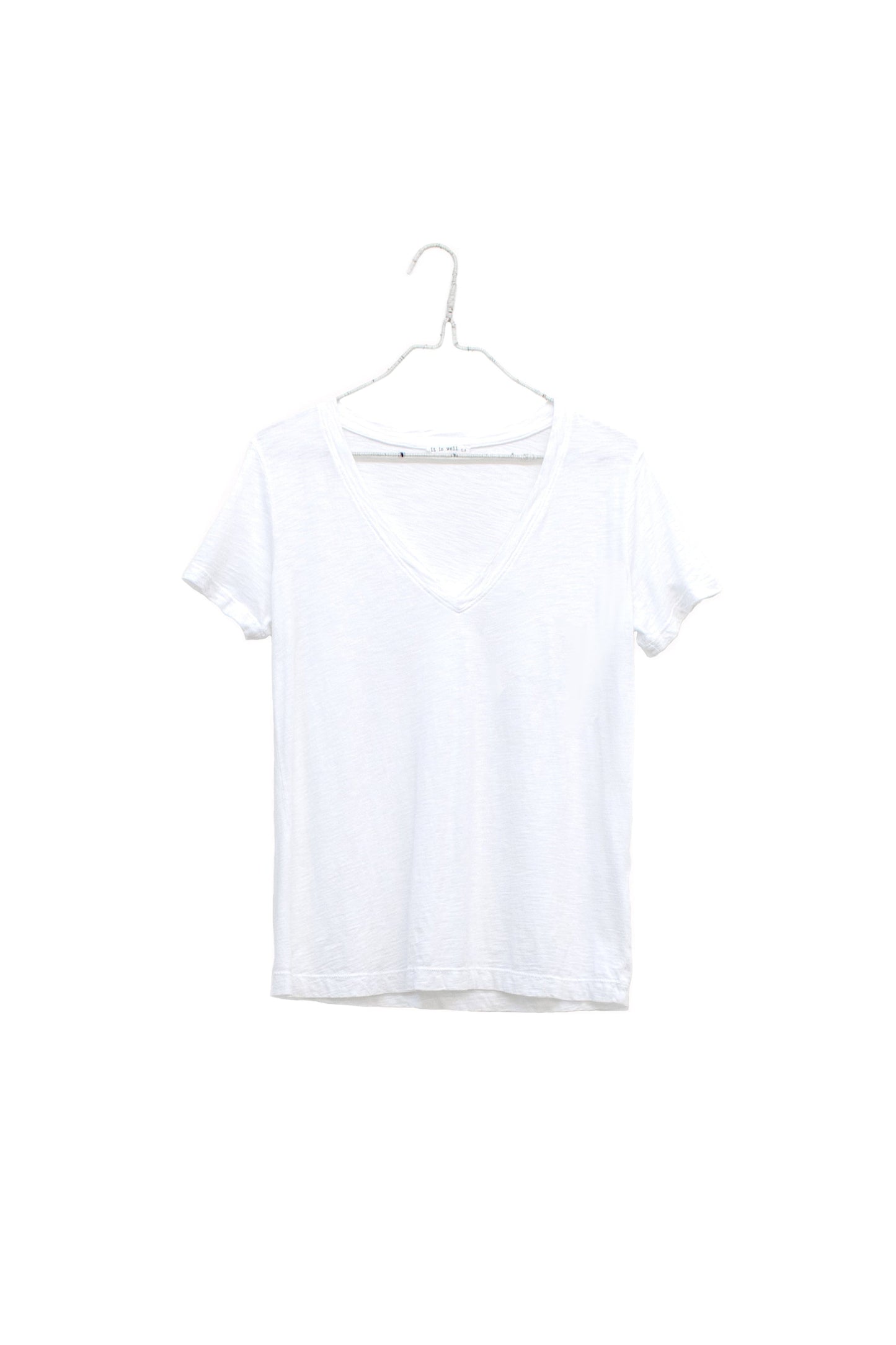 A white short-sleeve V-neck t-shirt hanging on a white plastic hanger against a plain white background.