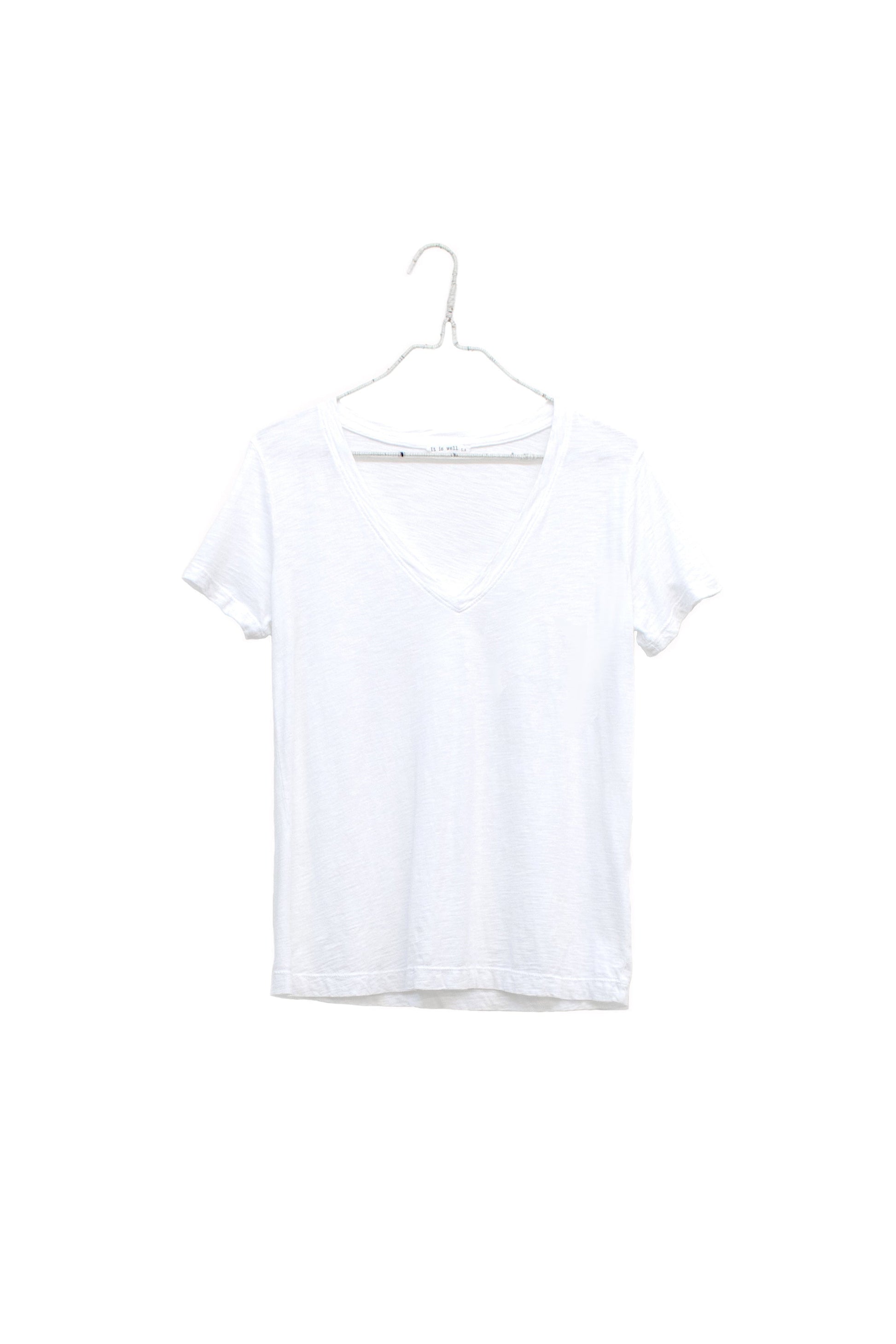 A white short-sleeve V-neck t-shirt hanging on a white plastic hanger against a plain white background.