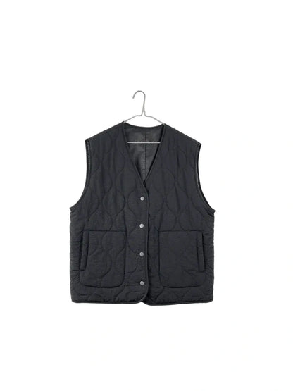 A black quilted sleeveless vest with snap-button front and two front patch pockets, hanging on a metal hanger against a plain white background.