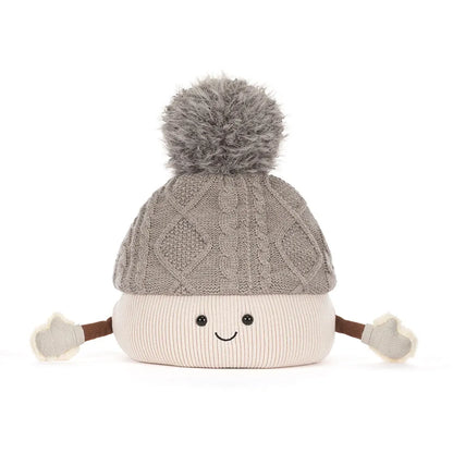A cute, smiling knit pom-pom hat with a gray cable-knit top section, a cream-colored bottom section, and small brown arms ending in cream mittens, shown on a solid white background.