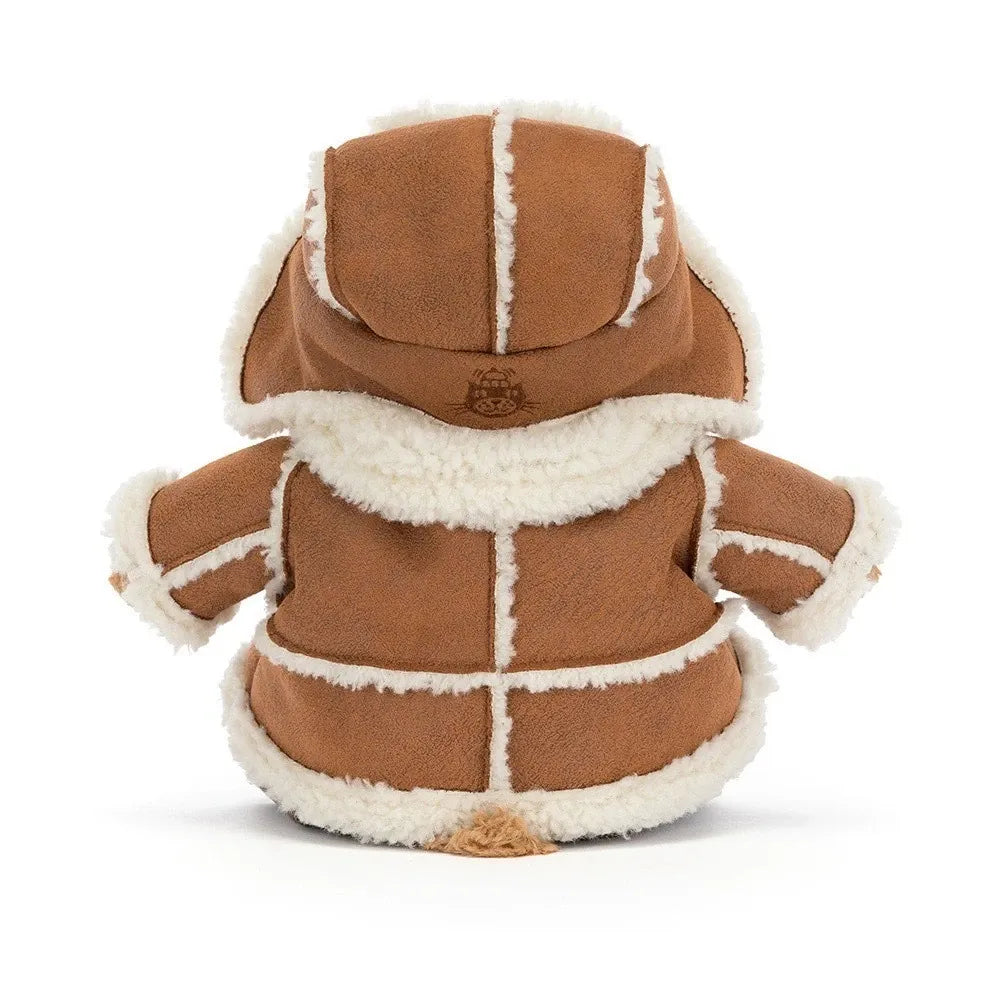 Back view of the Jellycat Bartholomew Bear Alpine, showing the tan coat with cream seam trim, the hood of the trapper hat with an embroidered Jellycat logo and a little tail peeking out.