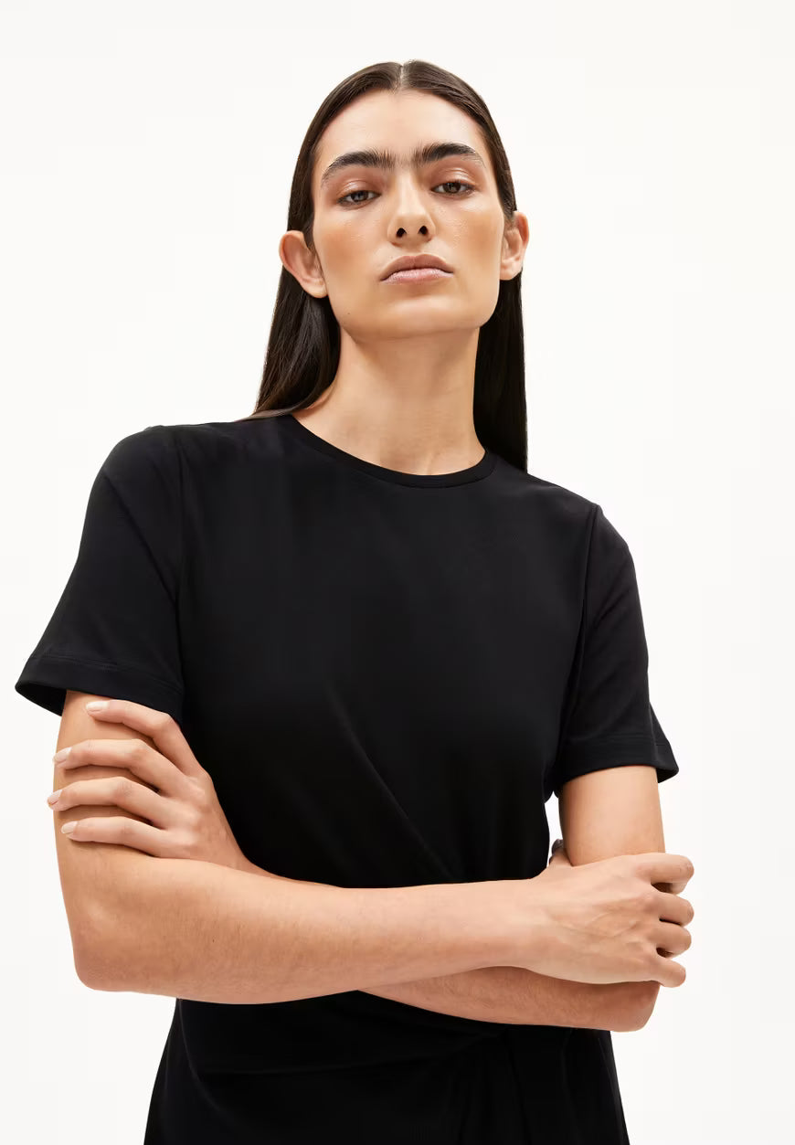 WAIST-UP PHOTO OF BLACK SHEATH WRAP DRESS ON MODEL WITH BLACK HAIR AGAINST WHITE BACKGROUND