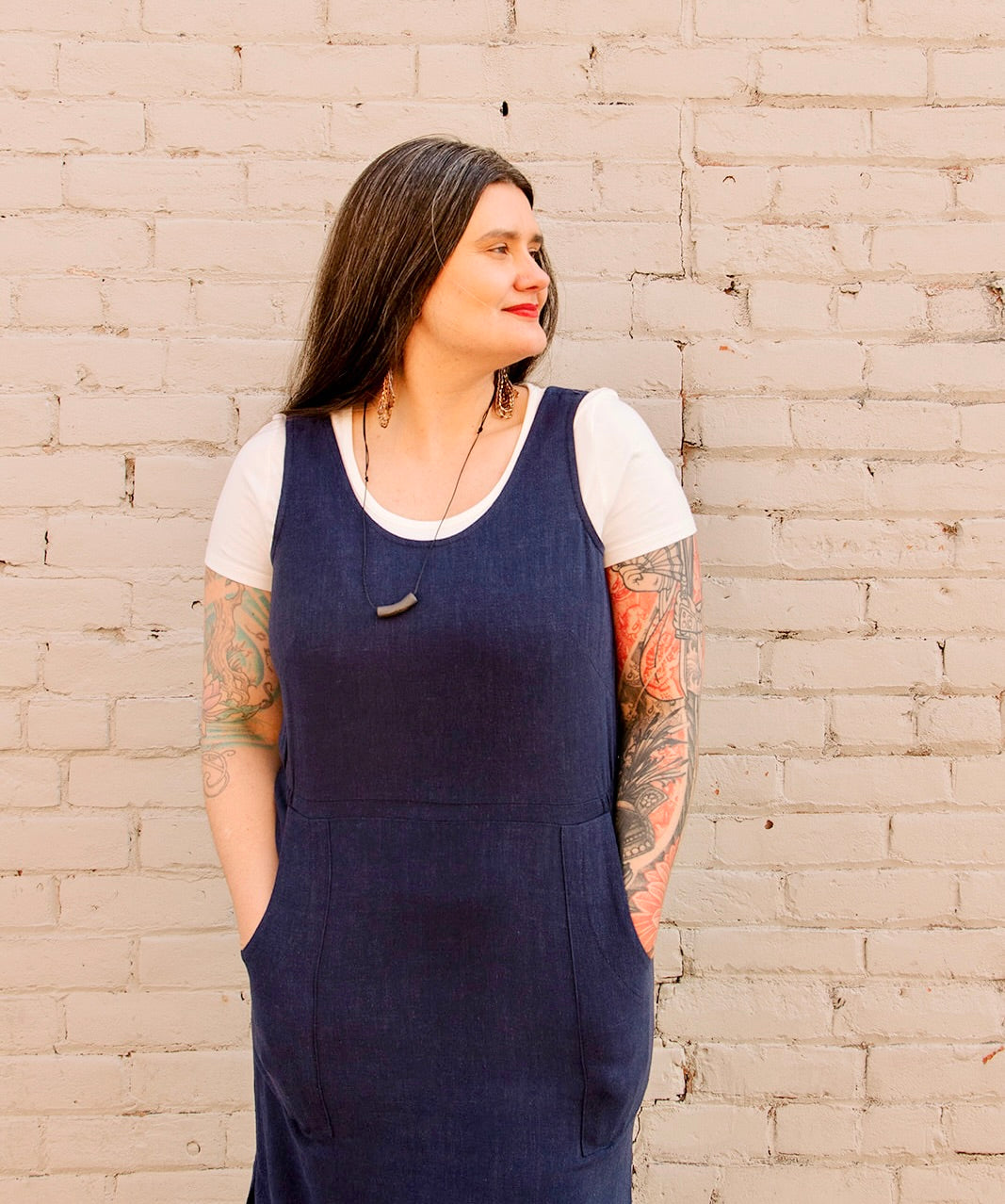Close-up of the Jennifer Glasgow Design Aisha Dress in Navy worn over a white tee, showing the scoop neckline, the textured linen blend and the deep front patch pockets