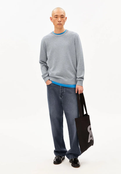 Men's ARMEDANGELS Canada  light gray sweater with blue neckline, styled with loose jeans and a black tote bag