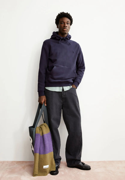 Men's ARMEDANGELS  Canada  Hoodie Paired with Dark Jeans and a Colorful Tote Bag