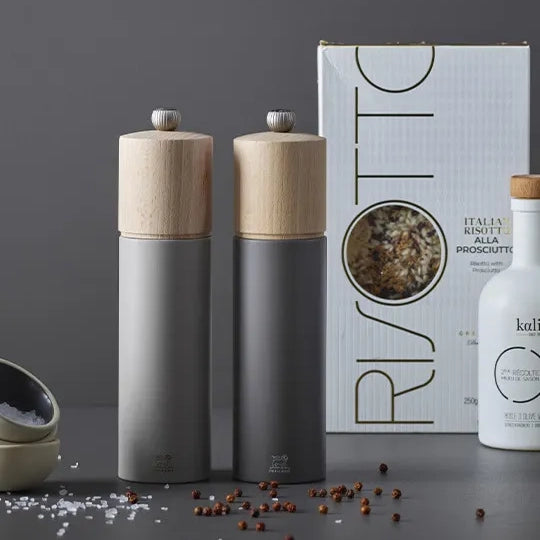 Peugeot Boreal Salt and Peppermill in front of pepper mix on a grey background