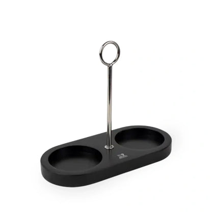 A black two-compartment tray with a central silver metal stand featuring a circular top, shown on a plain white background.