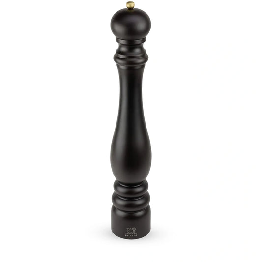 A tall black pepper mill with a small gold-toned metal knob on top, shown against a plain white background.