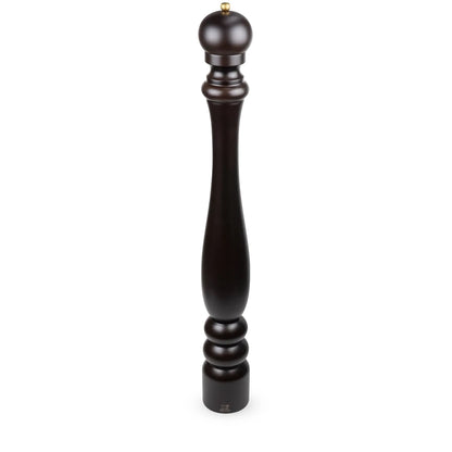 A tall, dark brown wooden pepper mill with a turned spindle design and a small brass top, shown on a plain white background.