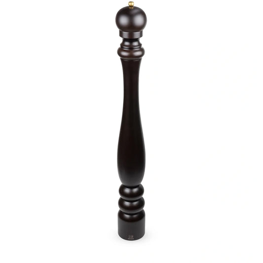 A tall, dark brown wooden pepper mill with a turned spindle design and a small brass top, shown on a plain white background.