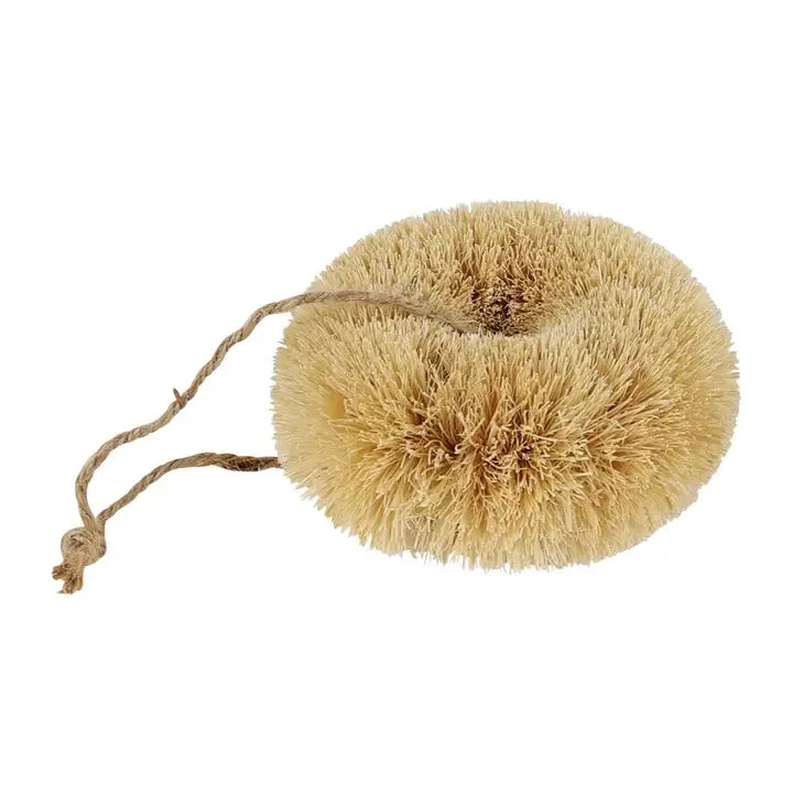 Natural fiber scrubber with a string on a white background