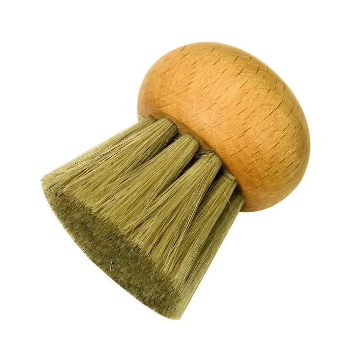 A small cleaning brush with a round light brown wooden handle and dense olive-green bristles, isolated on a white background.