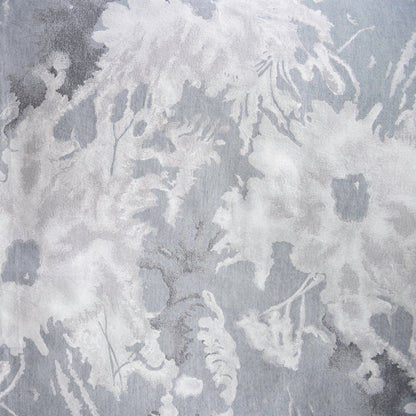 Close-up swatch of the Blossom jacquard in Moonlight, with pale silvery blooms over a cool grey-blue ground.