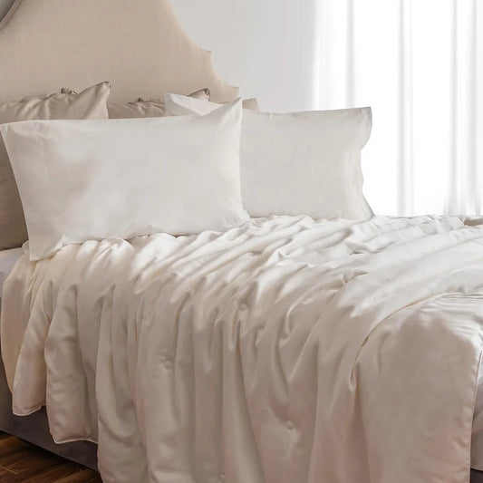 A white premium silk duvet cover with a 300 thread count lyocell sateen texture, displayed on a bed with two pillows.