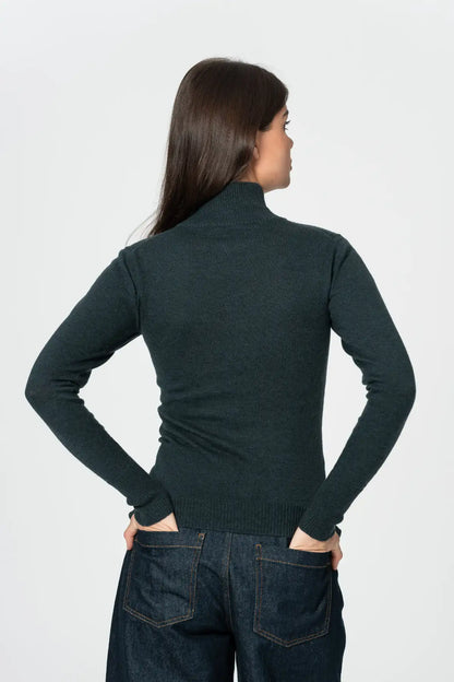 Back view of women's merino turtleneck sweater in dark green, designed for warmth and comfort